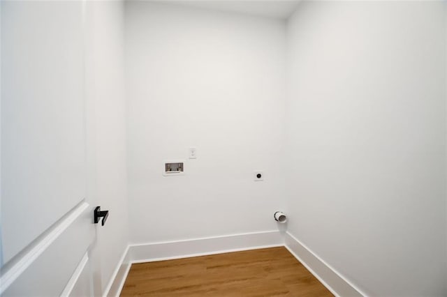 laundry area with hookup for an electric dryer, laundry area, washer hookup, baseboards, and light wood-style floors