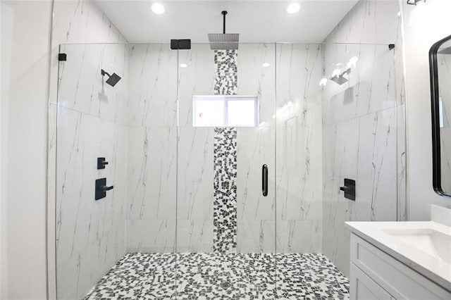 full bath with vanity and a marble finish shower