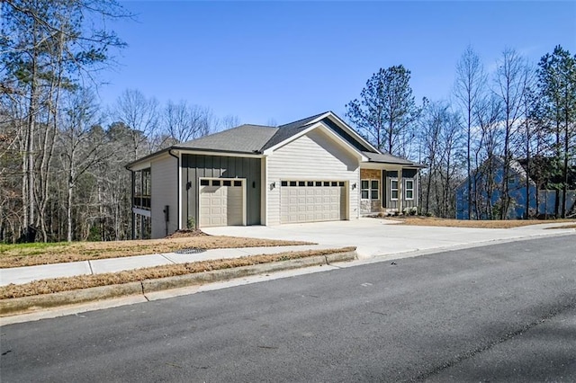 view of front of property with driveway, board and batten siding, and an attached garage