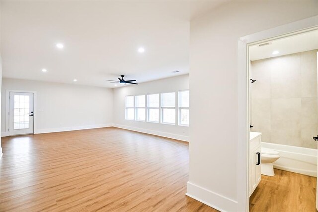 interior space with light wood finished floors, baseboards, a ceiling fan, and recessed lighting