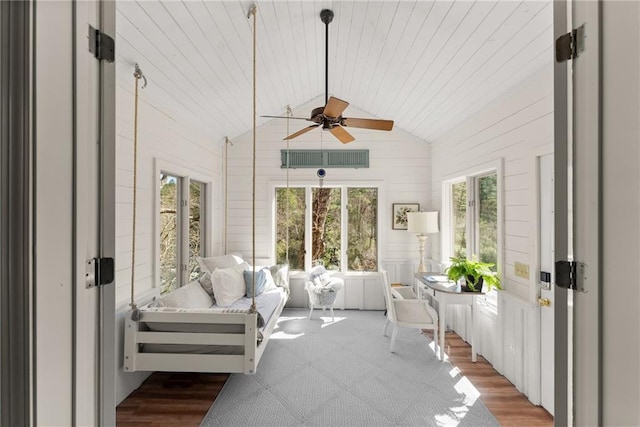 sunroom with ceiling fan, vaulted ceiling, and plenty of natural light