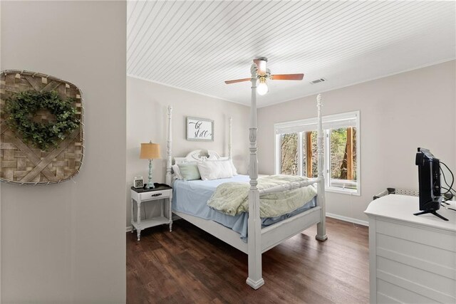 bedroom featuring a ceiling fan, wood finished floors, baseboards, and visible vents