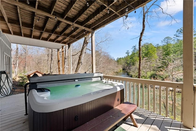wooden terrace with a covered hot tub