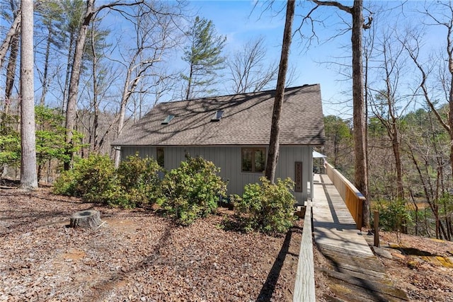 view of side of property with a shingled roof