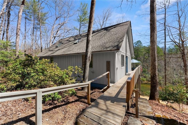 view of property exterior featuring a shingled roof