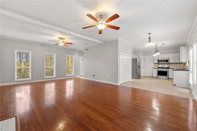 7165 Jonsway, Cumming, GA 30041 - unfurnished living room featuring a ceiling fan, light wood-style flooring, baseboards, a sink, and ornamental molding