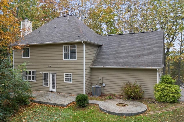 7165 Jonsway, Cumming, GA 30041 - rear view of property featuring a patio area, a chimney, roof with shingles, a yard, and central air condition unit