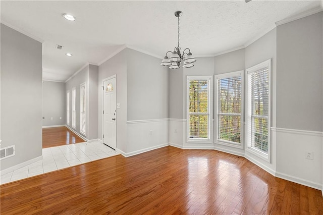7165 Jonsway, Cumming, GA 30041 - unfurnished dining area with wood finished floors, a chandelier, crown molding, baseboards, and recessed lighting