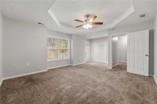 7165 Jonsway, Cumming, GA 30041 - unfurnished bedroom featuring a raised ceiling, carpet flooring, and baseboards