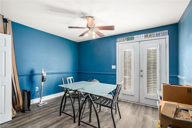dining room featuring french doors, baseboards, ceiling fan, and wood finished floors