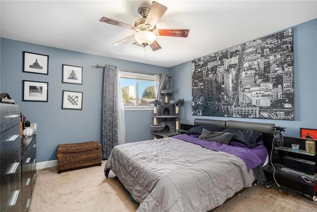carpeted bedroom featuring baseboards and ceiling fan