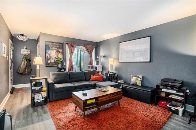 living room with baseboards and wood finished floors