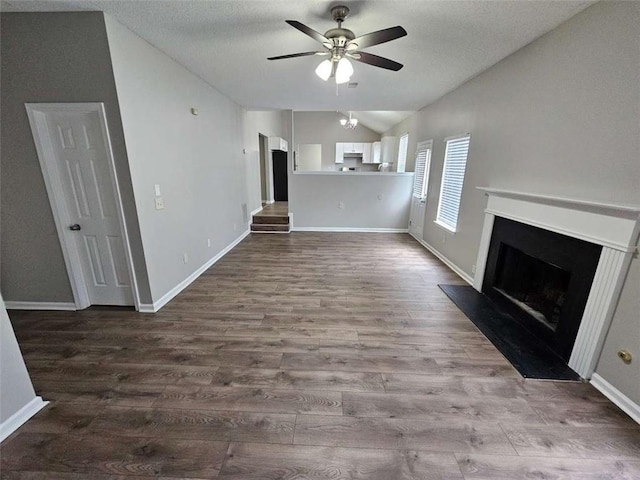 3763 Waldrop Hills Dr, Decatur, GA 30034 - unfurnished living room with lofted ceiling, dark wood-style flooring, a fireplace with raised hearth, a textured ceiling, and ceiling fan
