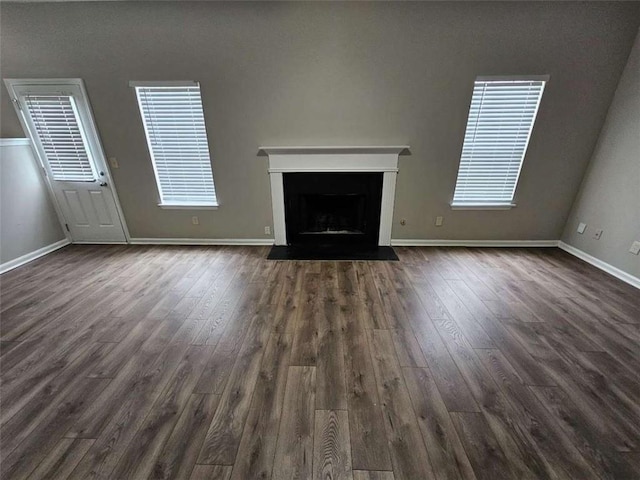 3763 Waldrop Hills Dr, Decatur, GA 30034 - unfurnished living room featuring a fireplace with flush hearth, baseboards, a wealth of natural light, and dark wood-style flooring
