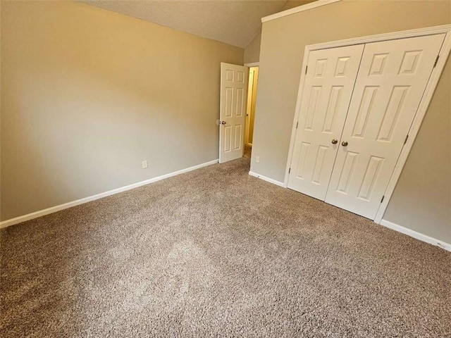 3763 Waldrop Hills Dr, Decatur, GA 30034 - unfurnished bedroom featuring baseboards, lofted ceiling, a closet, and carpet