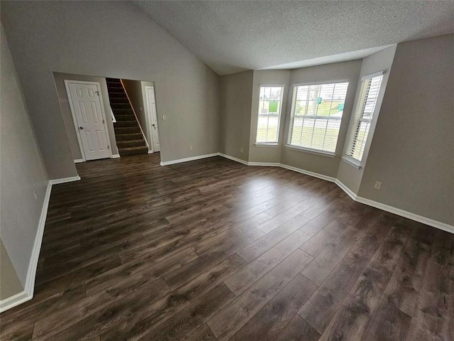 3763 Waldrop Hills Dr, Decatur, GA 30034 - unfurnished room featuring a textured ceiling, baseboards, stairway, dark wood finished floors, and vaulted ceiling