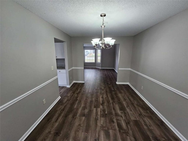 3763 Waldrop Hills Dr, Decatur, GA 30034 - unfurnished dining area with baseboards, dark wood-style flooring, a textured ceiling, and an inviting chandelier