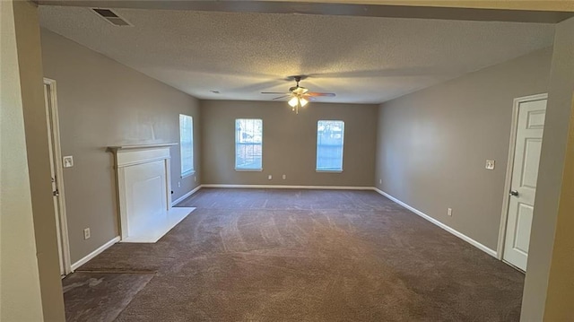 unfurnished living room featuring a textured ceiling, ceiling fan, and dark carpet