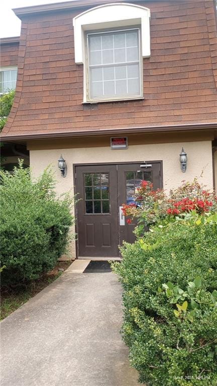 80 Place Fontaine, Lithonia, GA 30038 - doorway to property featuring stucco siding and roof with shingles