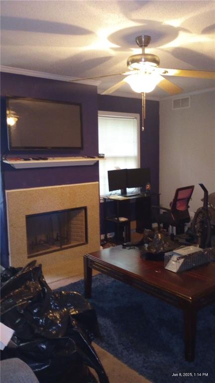 80 Place Fontaine, Lithonia, GA 30038 - living room with a fireplace, a ceiling fan, carpet flooring, and crown molding