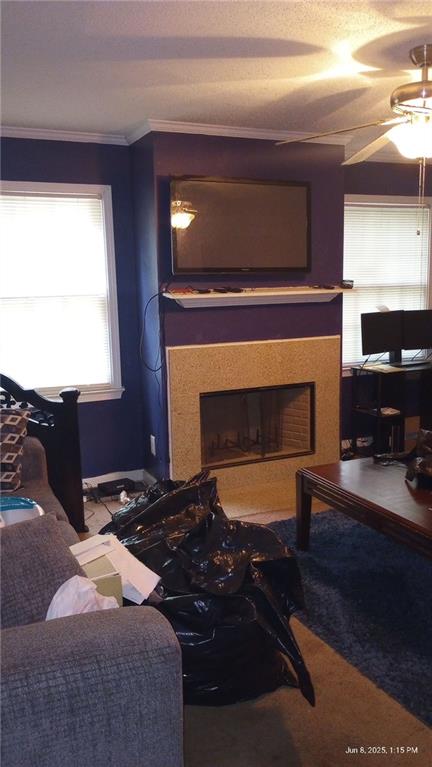 80 Place Fontaine, Lithonia, GA 30038 - carpeted living area featuring a fireplace, ornamental molding, and a ceiling fan