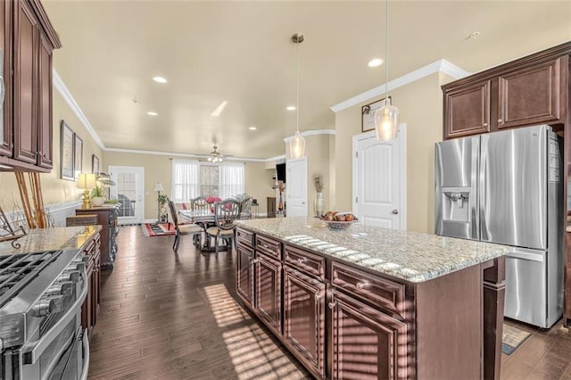 kitchen featuring a kitchen island, ornamental molding, appliances with stainless steel finishes, light stone countertops, and dark wood finished floors