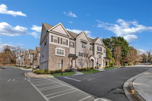 view of road with sidewalks, a residential view, and curbs