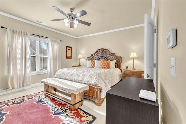 bedroom with baseboards, visible vents, light colored carpet, ceiling fan, and crown molding