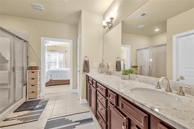 full bath with tile patterned flooring, visible vents, a sink, and a shower stall