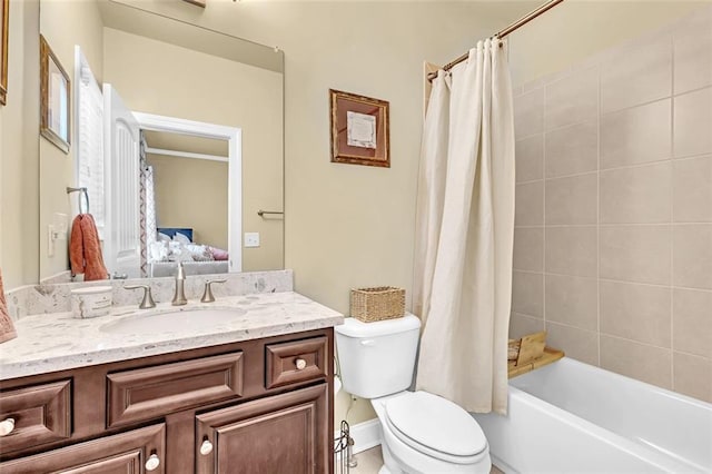 ensuite bathroom featuring shower / bath combination with curtain, vanity, toilet, and connected bathroom