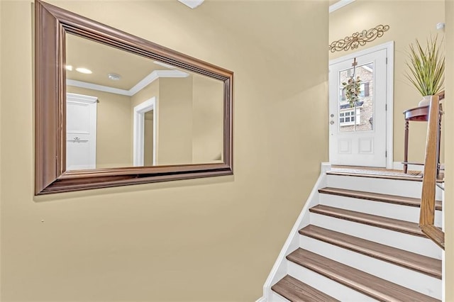 staircase featuring ornamental molding and baseboards