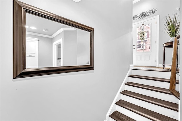 stairway featuring baseboards and crown molding