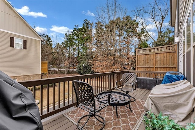 wooden deck featuring a grill