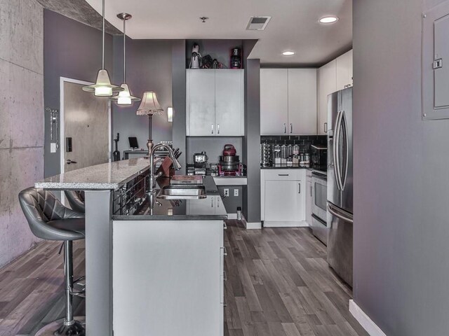 361 17th St NW Unit 1121, Atlanta, GA 30363 - kitchen with decorative light fixtures, sink, white cabinetry, and stainless steel fridge with ice dispenser