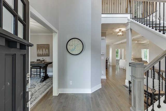 3441 Shoreland Dr, Buford, GA 30518 - foyer featuring wood finished floors, baseboards, ornamental molding, and stairs
