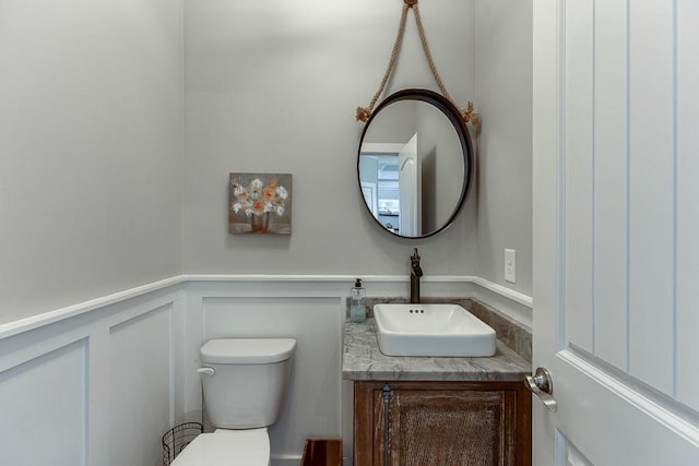 3441 Shoreland Dr, Buford, GA 30518 - bathroom with vanity, toilet, wainscoting, and a decorative wall