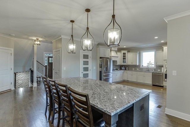 3441 Shoreland Dr, Buford, GA 30518 - kitchen with stainless steel appliances, a sink, crown molding, decorative backsplash, and light stone counters