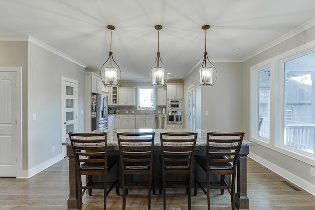 3441 Shoreland Dr, Buford, GA 30518 - dining area featuring dark wood-style flooring, baseboards, and crown molding