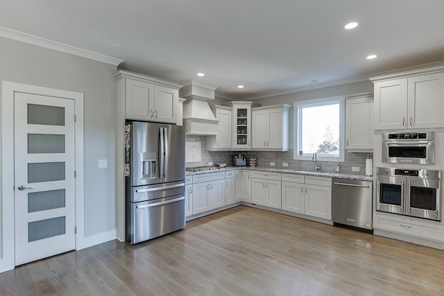 3441 Shoreland Dr, Buford, GA 30518 - kitchen featuring stainless steel appliances, ornamental molding, custom exhaust hood, decorative backsplash, and a sink