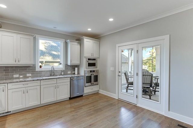 3441 Shoreland Dr, Buford, GA 30518 - kitchen featuring dishwasher, a sink, crown molding, decorative backsplash, and plenty of natural light