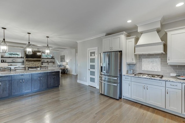 3441 Shoreland Dr, Buford, GA 30518 - kitchen featuring appliances with stainless steel finishes, crown molding, tasteful backsplash, pendant lighting, and light wood-type flooring