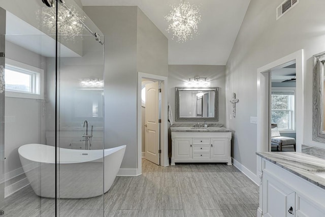 3441 Shoreland Dr, Buford, GA 30518 - full bath with vanity, a freestanding tub, lofted ceiling, and baseboards