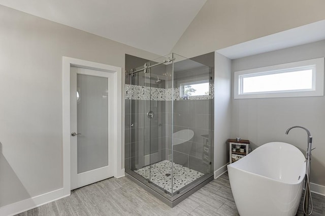3441 Shoreland Dr, Buford, GA 30518 - bathroom featuring a soaking tub, a shower stall, wood finished floors, baseboards, and lofted ceiling