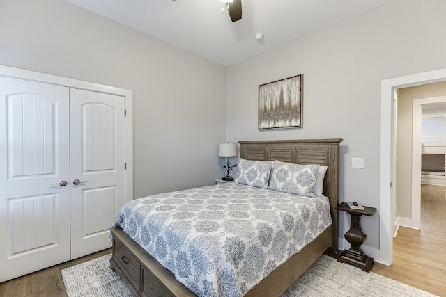 3441 Shoreland Dr, Buford, GA 30518 - bedroom featuring light wood-type flooring, a closet, ceiling fan, and baseboards