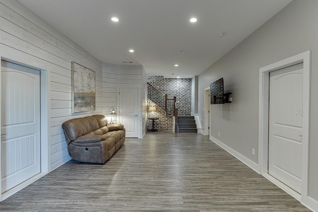 3441 Shoreland Dr, Buford, GA 30518 - living area with stairs, recessed lighting, wood finished floors, wood walls, and baseboards