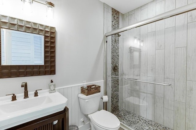 3441 Shoreland Dr, Buford, GA 30518 - bathroom with toilet, a stall shower, vanity, and a wainscoted wall