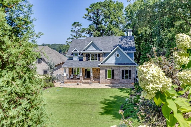 3441 Shoreland Dr, Buford, GA 30518 - craftsman-style home featuring covered porch, a front lawn, a chimney, and brick siding