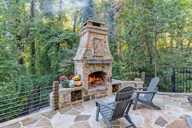 3441 Shoreland Dr, Buford, GA 30518 - view of patio / terrace featuring an outdoor stone fireplace and a forest view
