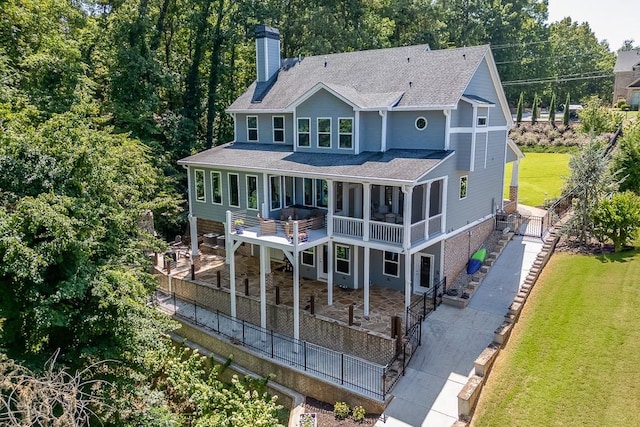 3441 Shoreland Dr, Buford, GA 30518 - back of property with a chimney, a shingled roof, a yard, and a patio area