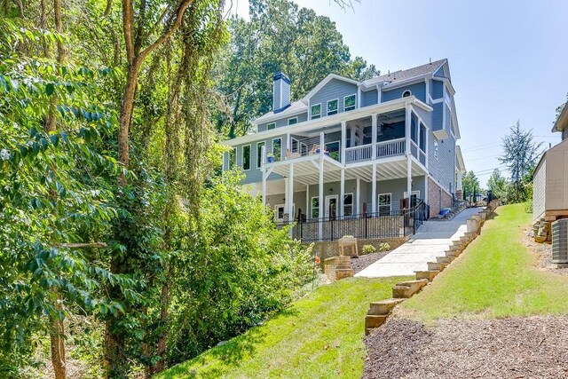 3441 Shoreland Dr, Buford, GA 30518 - back of house with a ceiling fan, a chimney, stairway, a yard, and a patio